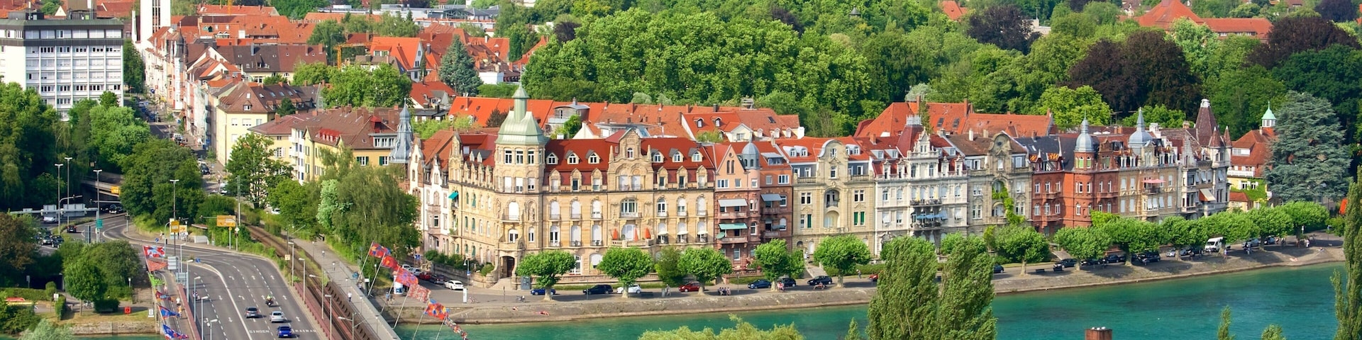 A riverside town with historic buildings, a bridge, and a river.
