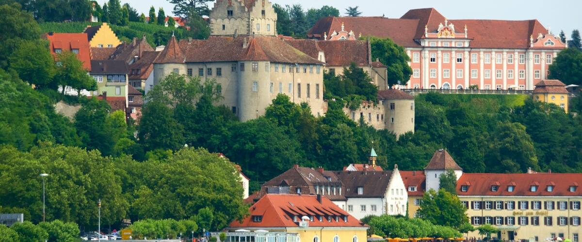 A historic town with a castle, a waterfront, and traditional buildings.