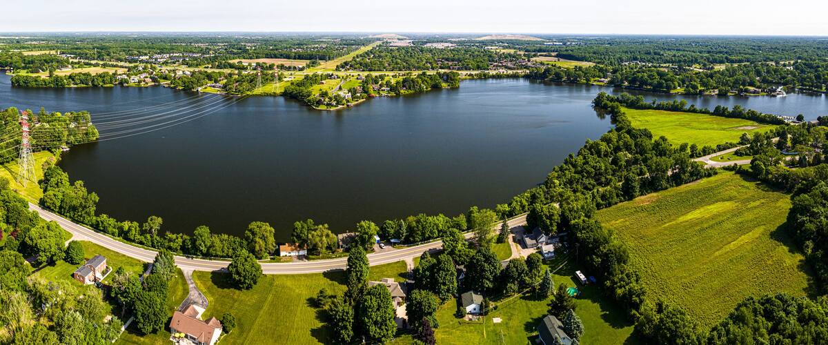 A large lake surrounded by greenery and residential areas.