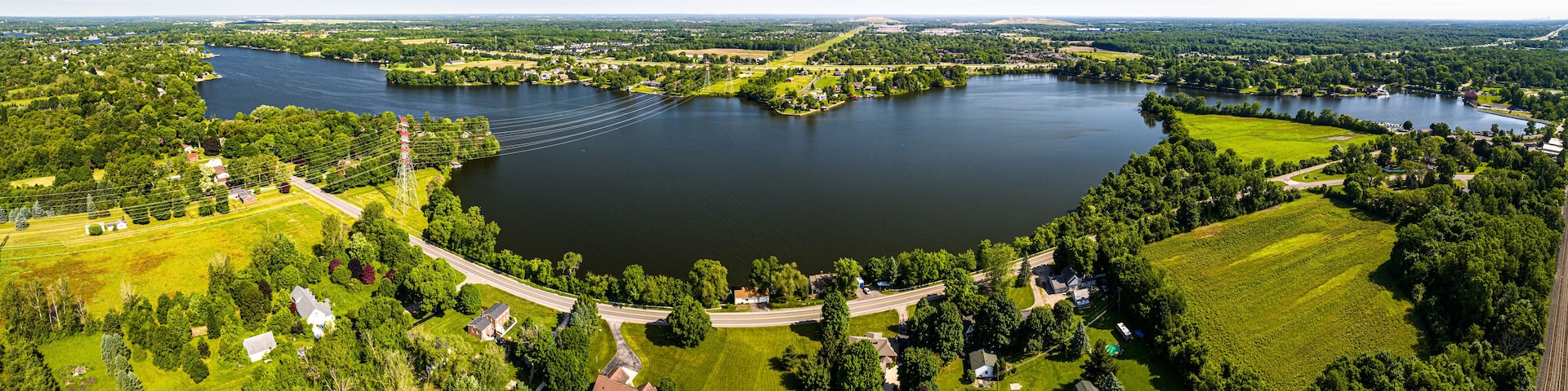 A large lake surrounded by greenery and residential areas.