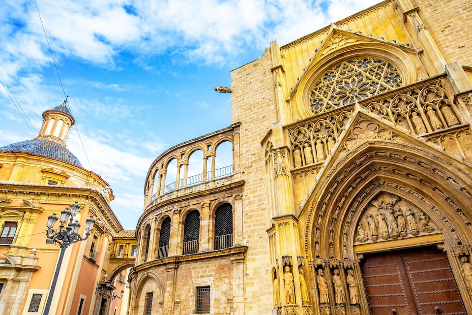 A historic cathedral with a large rose window and a dome.