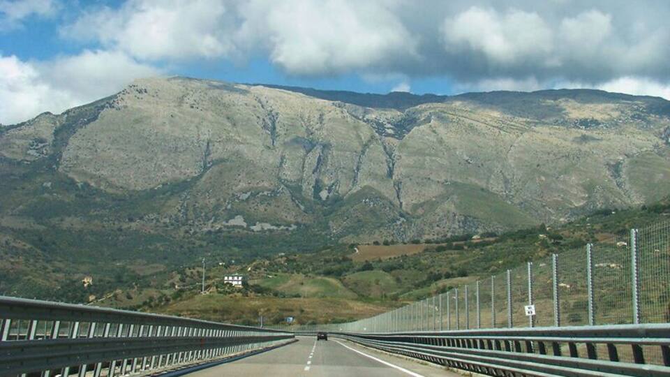 A highway with a mountain in the background.