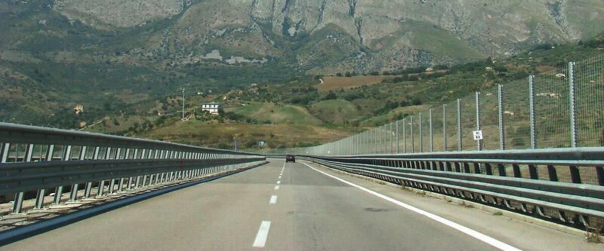 A highway with a mountain in the background.
