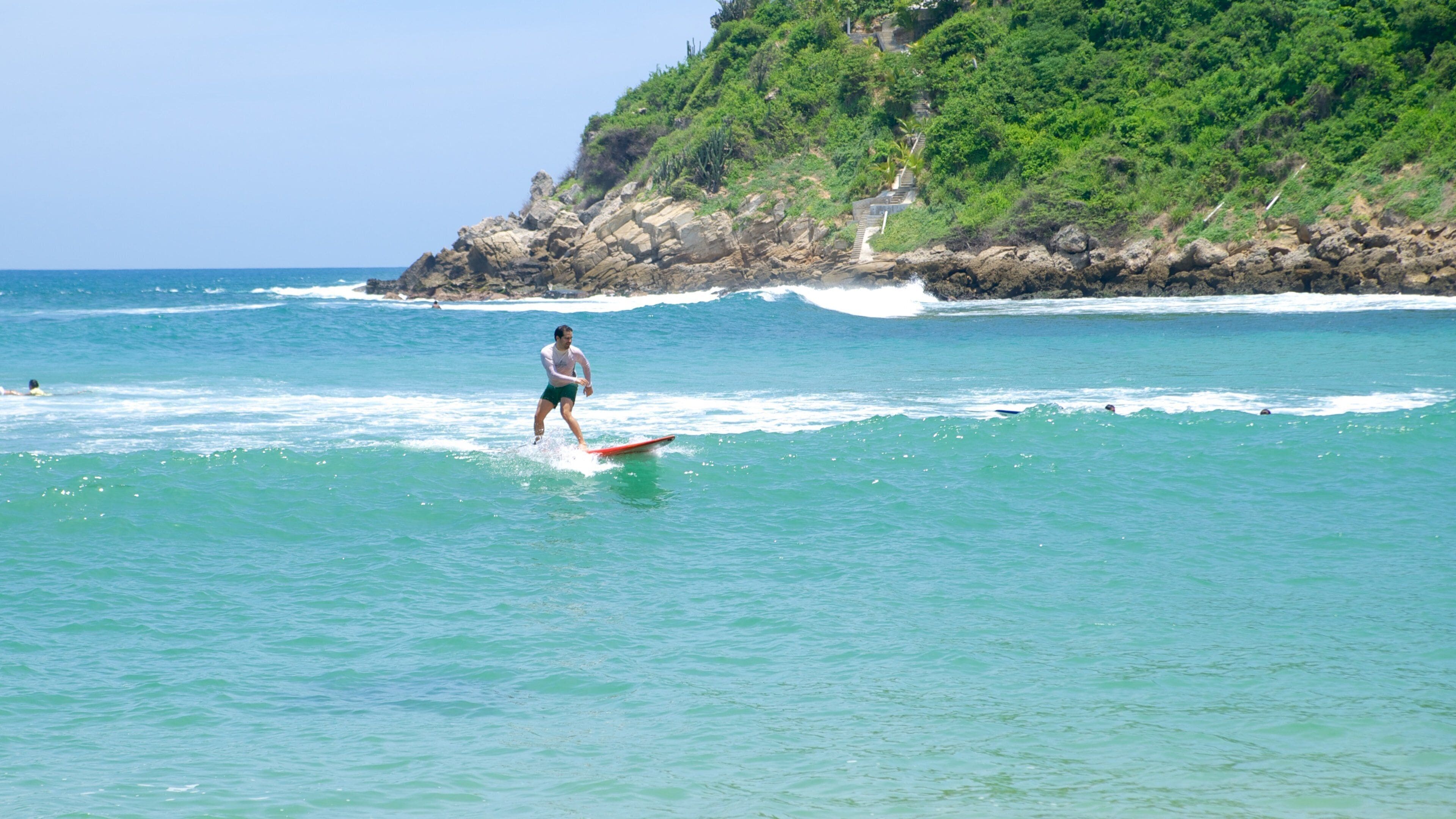 Carrizalillo Beach which includes surfing, waves and rocky coastline