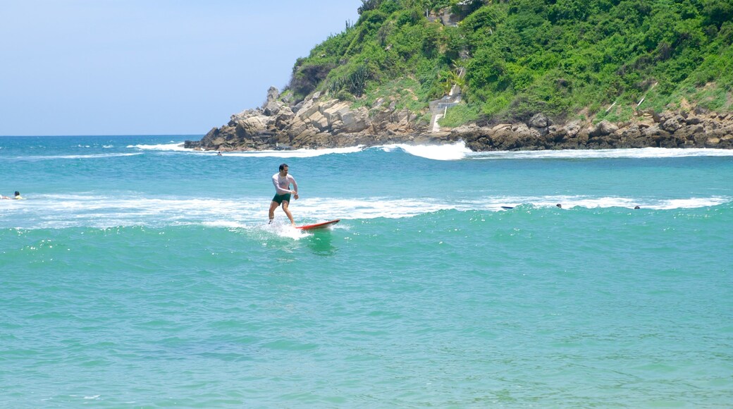 Carrizalillo Beach which includes surfing, waves and rocky coastline