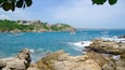 Puerto Angelito Beach featuring a bay or harbour and rocky coastline
