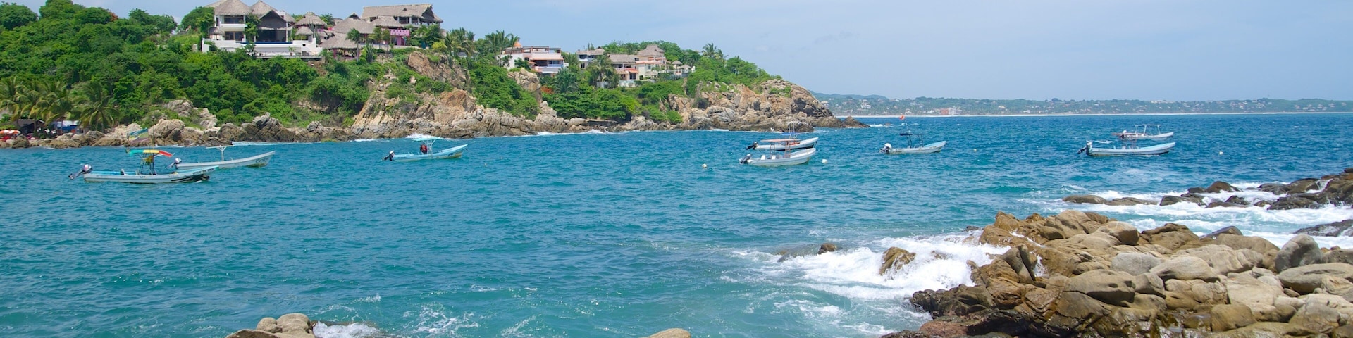 Puerto Angelito Beach showing rocky coastline and a bay or harbor