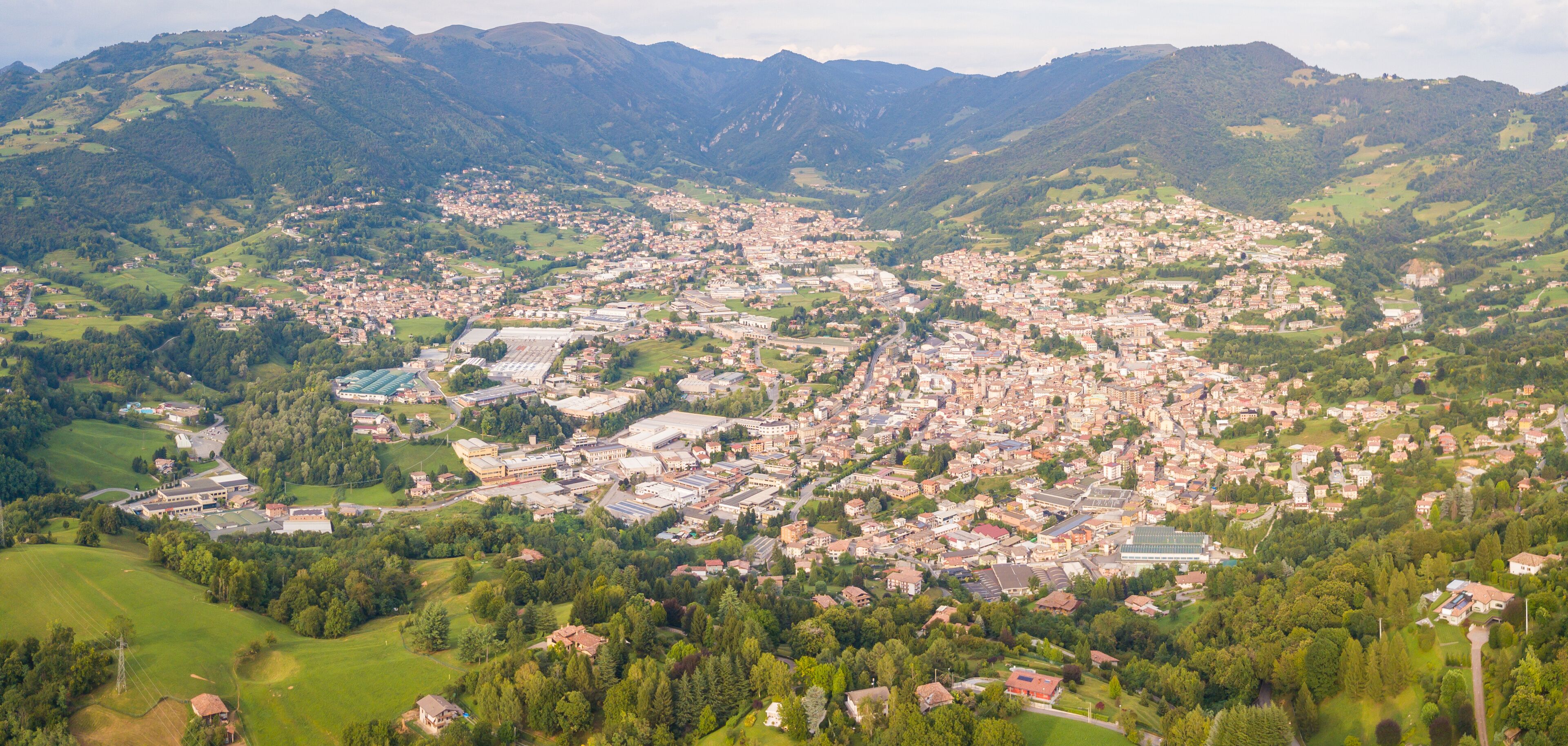 A town nestled in a valley surrounded by mountains.