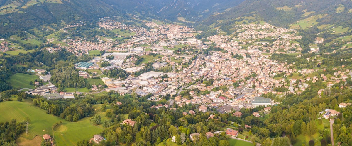 A town nestled in a valley surrounded by mountains.