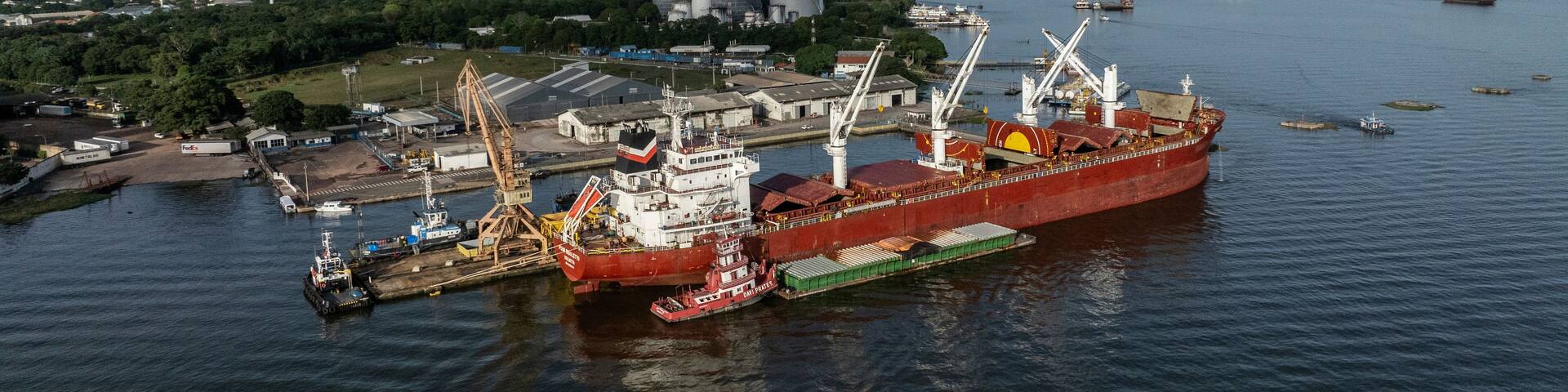 Santarem, Brazil - 08 May 2023: Aerial view of cargo ships and cranes at a bustling port along the river, Santarem, Para, Brazil.