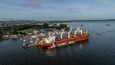 Santarem, Brazil - 08 May 2023: Aerial view of cargo ships and cranes at a bustling port along the river, Santarem, Para, Brazil.