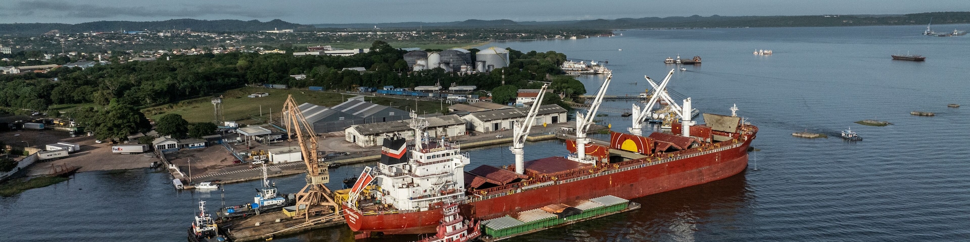 Santarem, Brazil - 08 May 2023: Aerial view of cargo ships and cranes at a bustling port along the river, Santarem, Para, Brazil.