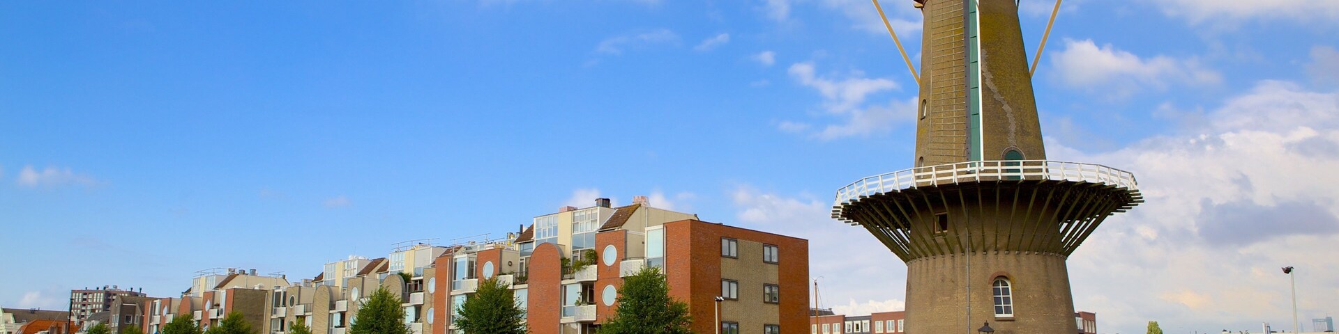 Delfshaven showing a windmill, a bay or harbor and a river or creek