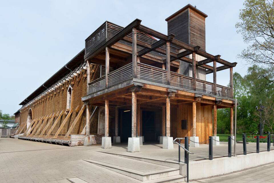 A wooden building with a balcony and a chimney.