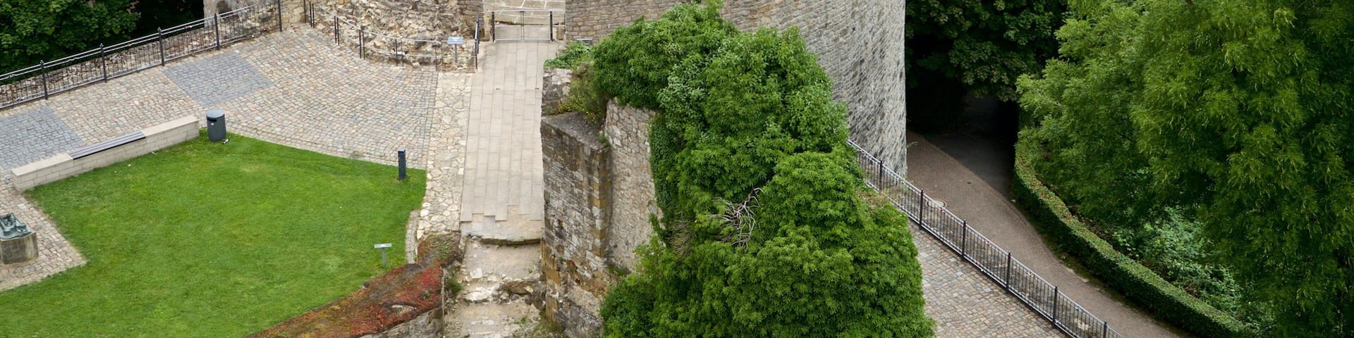 A circular stone structure surrounded by dense forest.