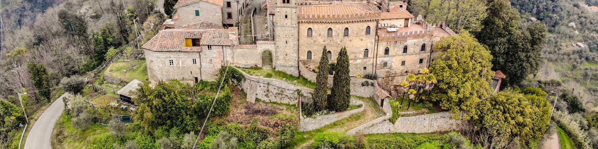 A historic village with stone buildings and a winding road.
