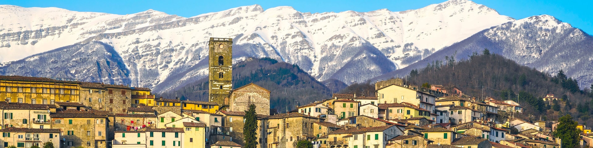 Coreglia Antelminelli village and snowy mountains on background. Garfagnana, Tuscany, Italy.