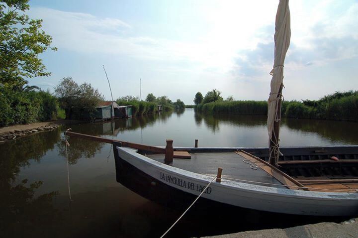 A narrow waterway with a boat docked at the edge.