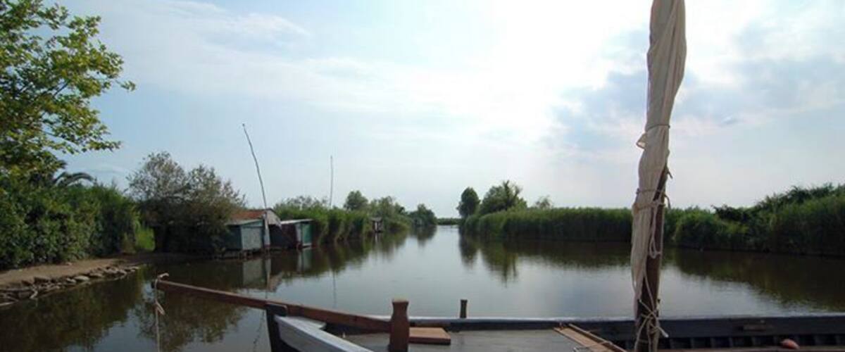 A narrow waterway with a boat docked at the edge.