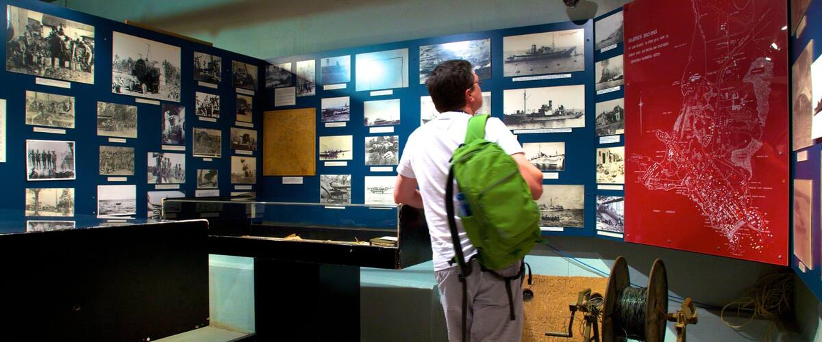 Defence Of Darwin Experience showing interior views and military items as well as an individual male