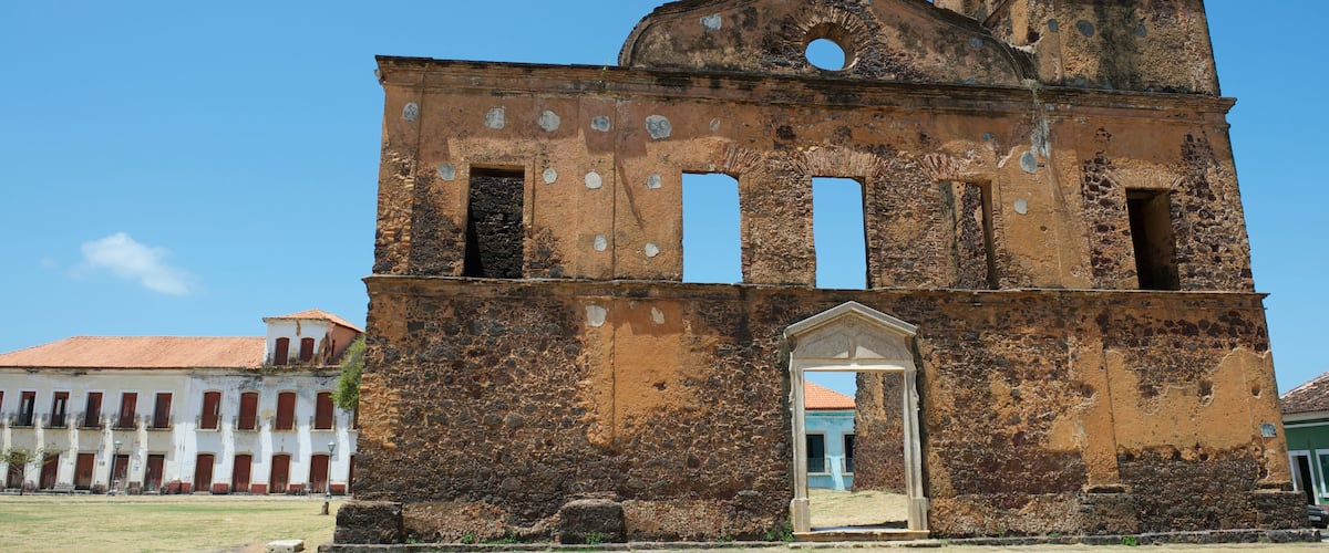 An old, weathered church with a bell tower and arched windows.