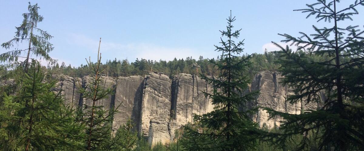 A forested landscape with towering rock formations.