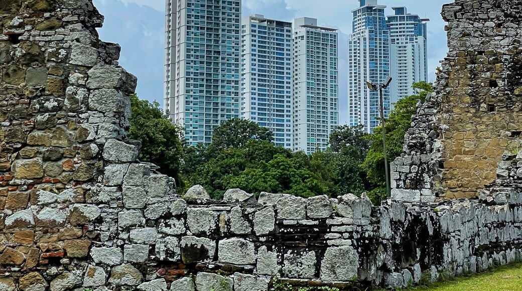 Old ruins of historic city of Panama Viejo, framing modern multi-story buildings