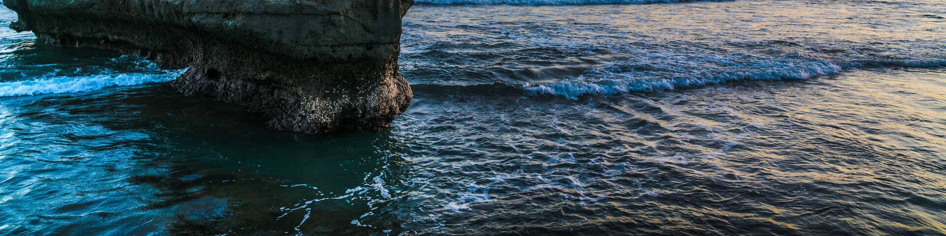 Sunset beach in Bali - Echo beach. Rocks, waves and magic sea landscape view with a beautiful evening sky. Indonesia, Indian Ocean; Shutterstock ID 637110094; Purchase Order: -