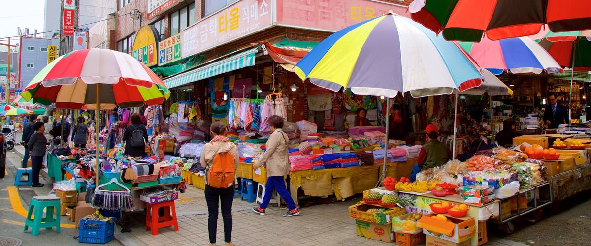Gukje Market showing markets as well as a small group of people