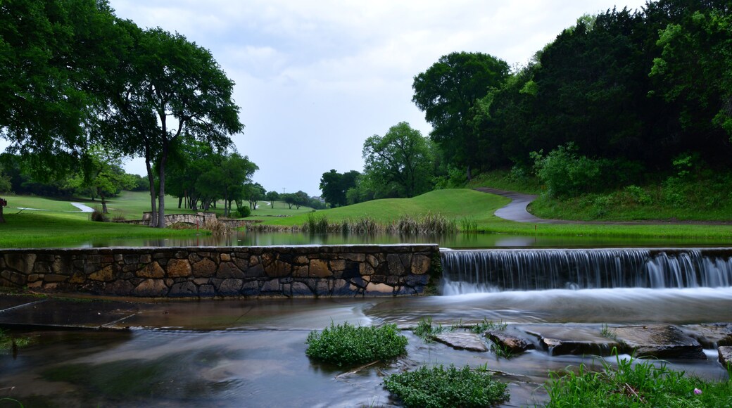 Gold course cart path crossing a small stream late in the evening after a rain shower in Leander TX.