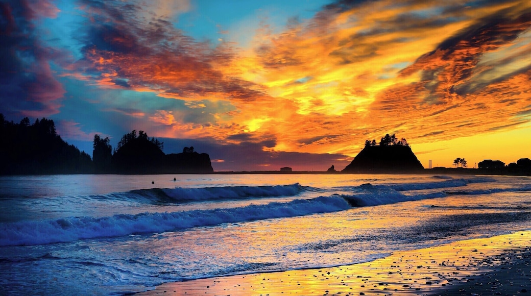 We watched surfers underneath a colorful sunset.