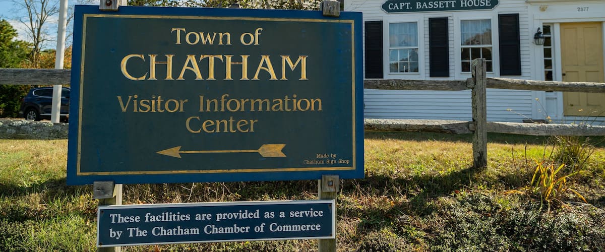 A sign for the Town of Chatham Visitor Information Center with a directional arrow.