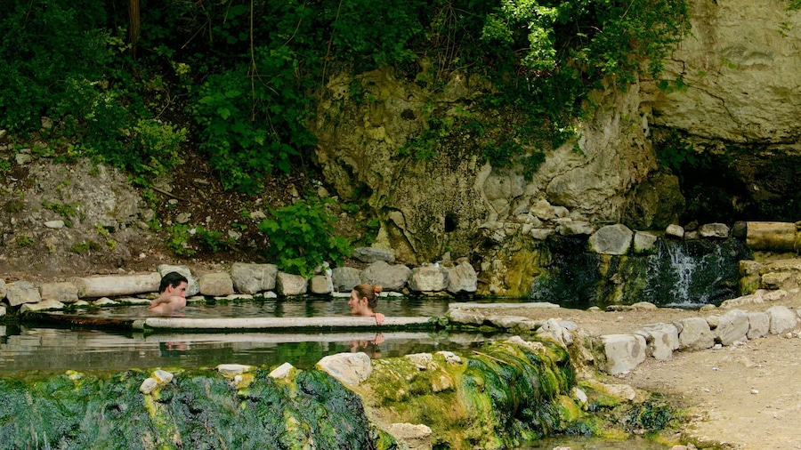 Bagni San Filippo showing a lake or waterhole as well as a couple