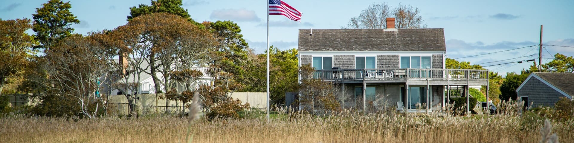 Barnstable County featuring a house, a small town or village and wildflowers
