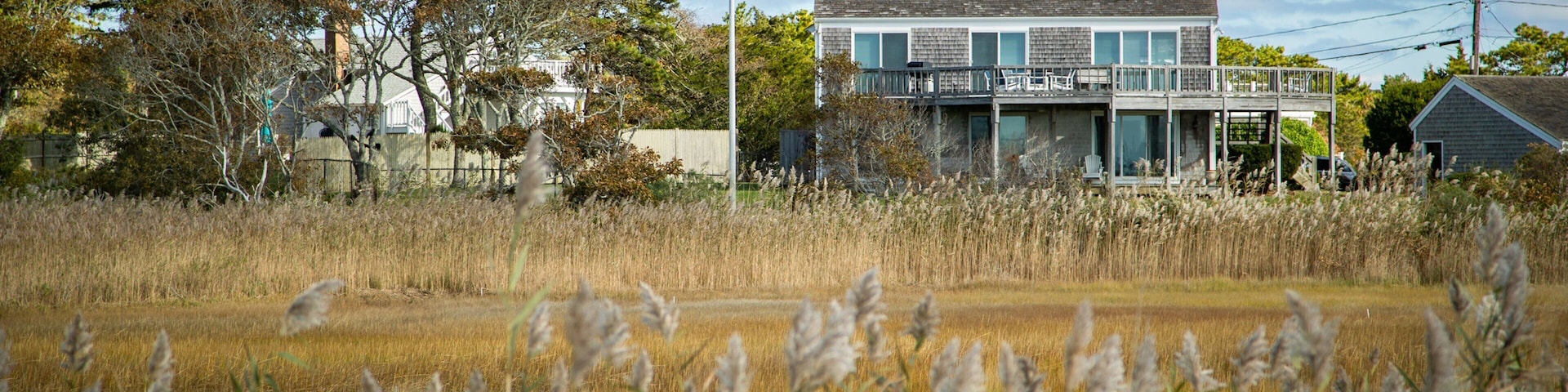 Barnstable County featuring a house, a small town or village and wildflowers