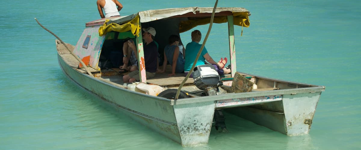 Manono showing boating and tropical scenes as well as a small group of people