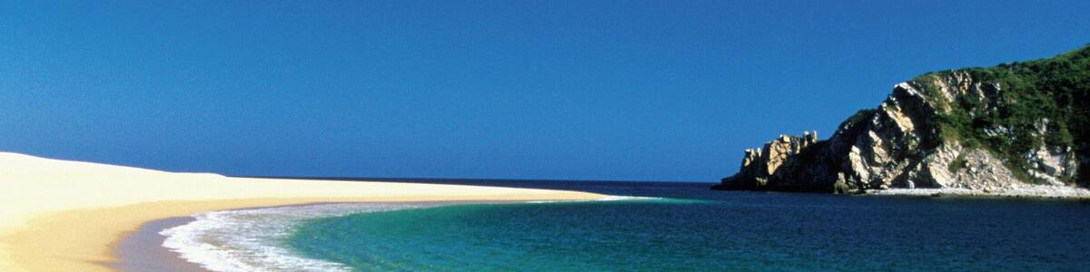 Footprints in the sand on Cacaluta Bay beach in Huatulco, Mexico