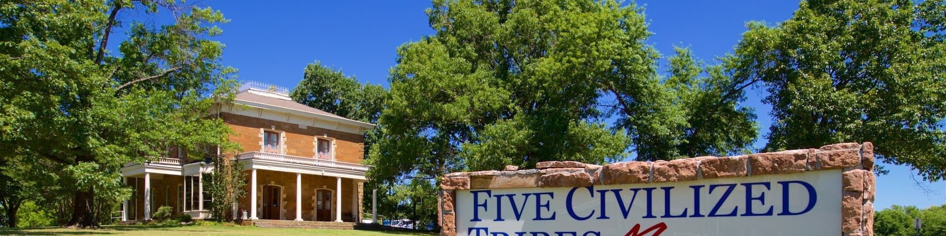 Five Civilized Tribes Museum featuring heritage elements, signage and a house