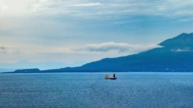 Panoramic view of the Sakurajima volcano in eruption from the shores of the city of Kagoshima, Kyushu, Japan