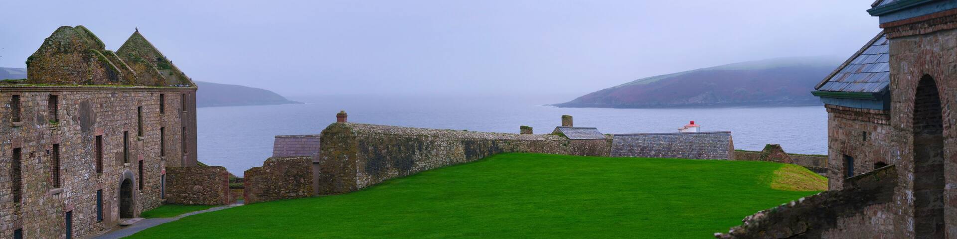 Tranquil seascape and Charles Fort, or Dún Chathail, the imposing remains of a late 1600s fortification overlooking the River Bandon and Celtic Sea along the Wild Atlantic Way in Kinsale, Ireland
