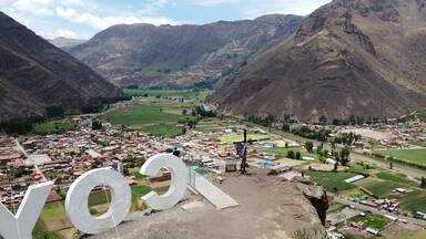 Drone lookout coya glass bridge Aerial view of Village of Coya and the Urubamba river, Sacred Valley, Cusco, Peru