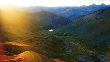 A mountainous landscape with a valley and a river.