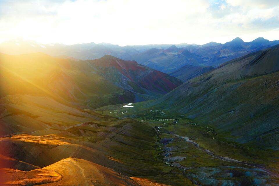 A mountainous landscape with a valley and a river.