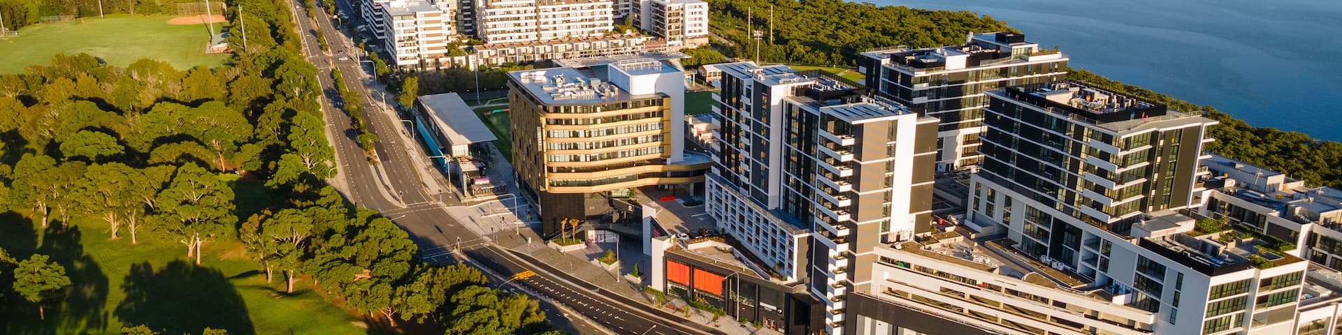 Aerial drone view of residential and retail buildings at Woolooware Bay in the Sutherland Shire, South Sydney, NSW Australia during a sunny morning in February 2024