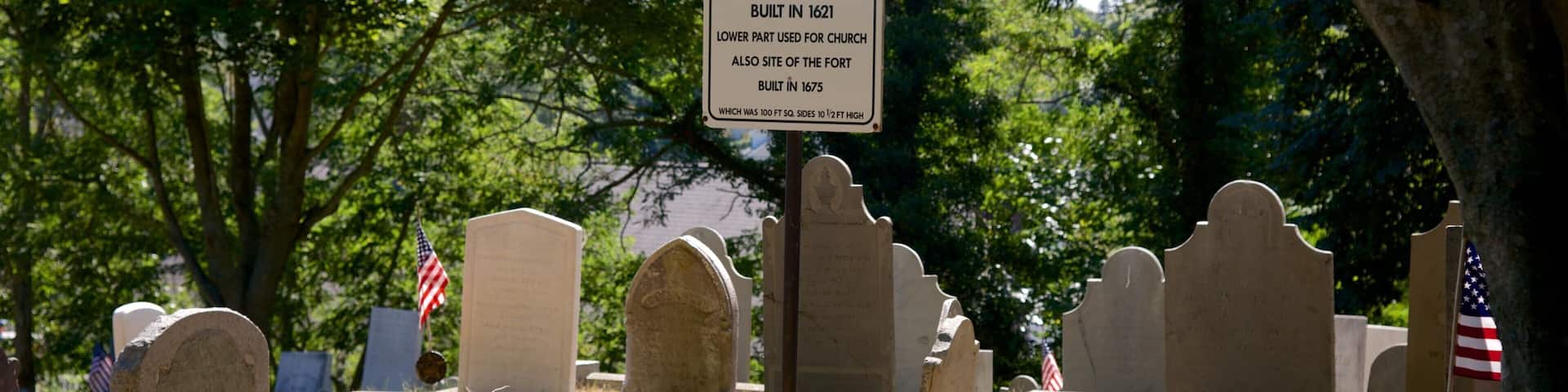 Burial Hill featuring signage and a cemetery