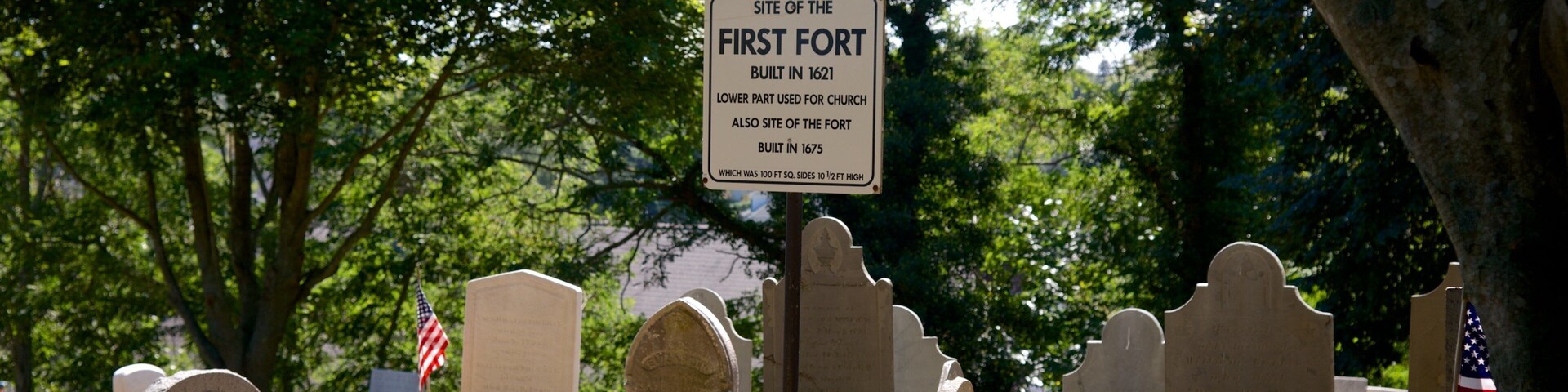 Burial Hill featuring signage and a cemetery