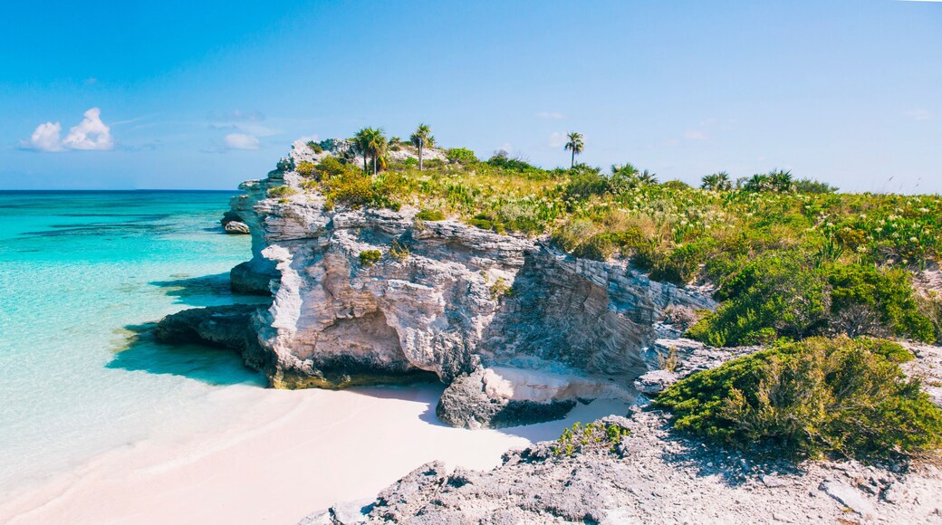 Turquoise blue waters, dramatic limestone cliffs, and powder soft white sand beach at Lighthouse Point on the island of Eleuthera, The Bahamas