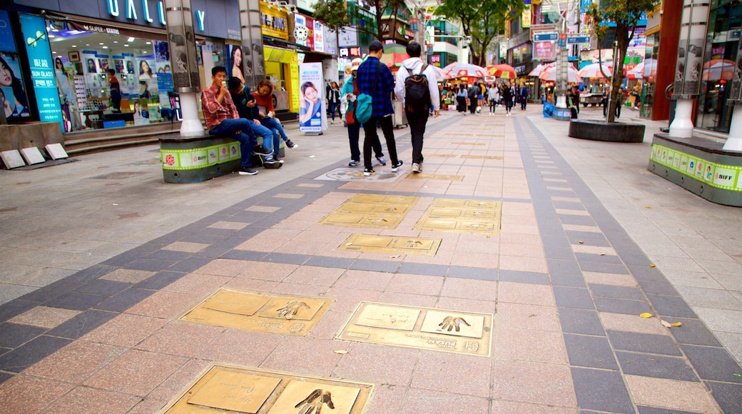 BIFF Square featuring a city as well as a small group of people