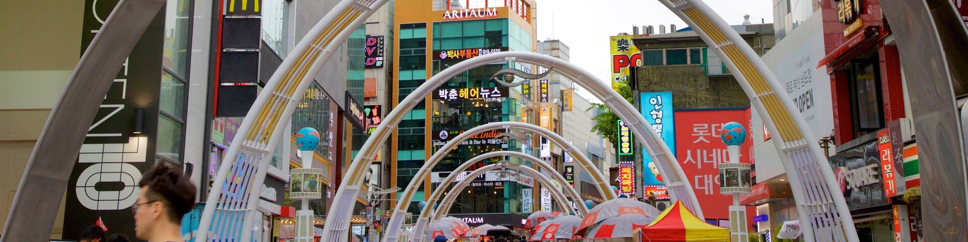 A busy urban street with a large archway advertising the Busan International Film Festival.