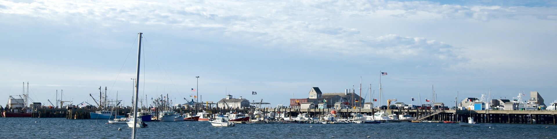MacMillan Pier featuring a bay or harbor and a sandy beach